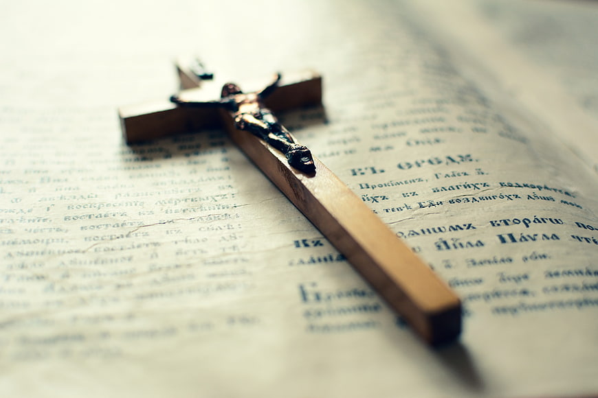 Wooden Cross Resting on Open Orthodox Bible Page