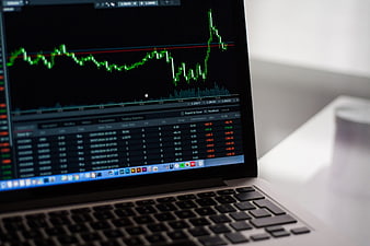 Laptop displaying financial stock market trading charts
