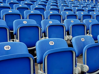 Rows of empty blue stadium seats with numbers