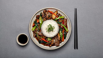 Top View Beef Stir Fry with Rice and Vegetables on Gray Background