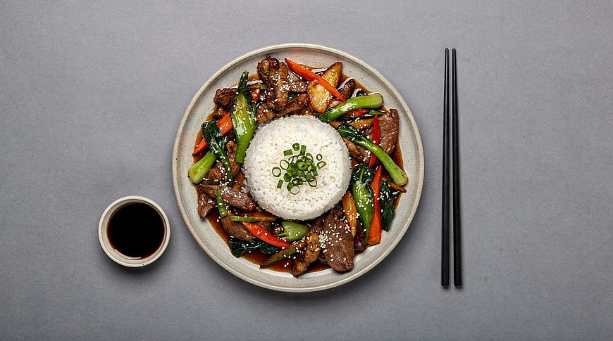 Top View Beef Stir Fry with Rice and Vegetables on Gray Background