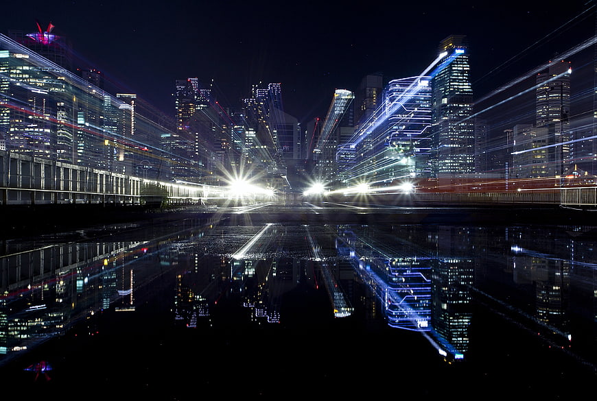 Futuristic Cityscape with Light Trails and Water Reflection