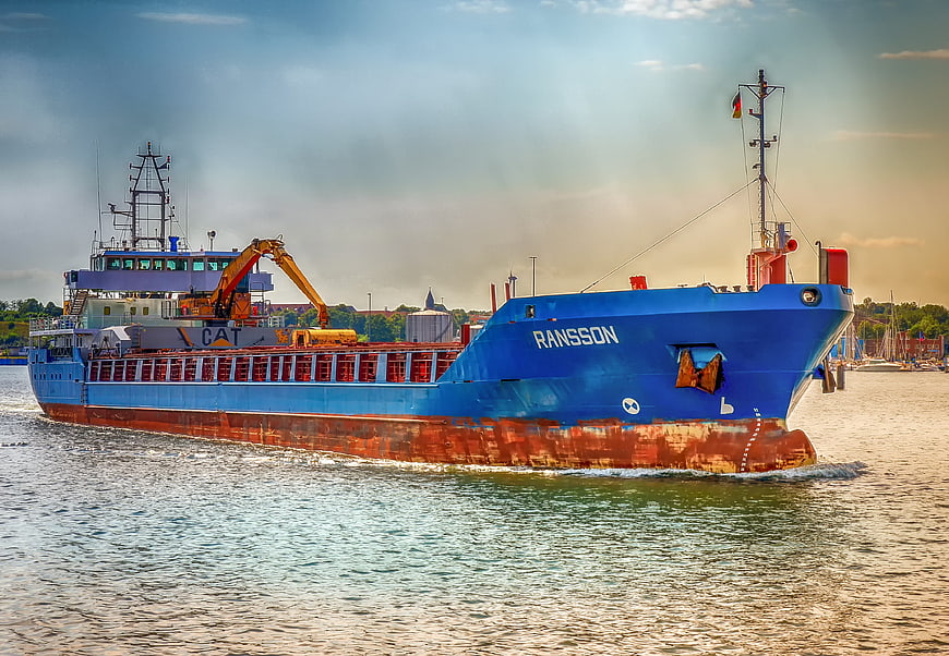 Blue Cargo Ship Ransson Sailing in Harbor