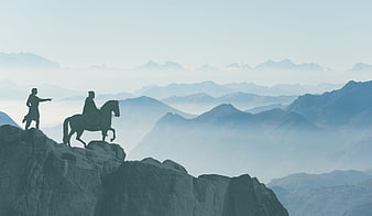 Silhouettes of Medieval Figures on Mountain Summit