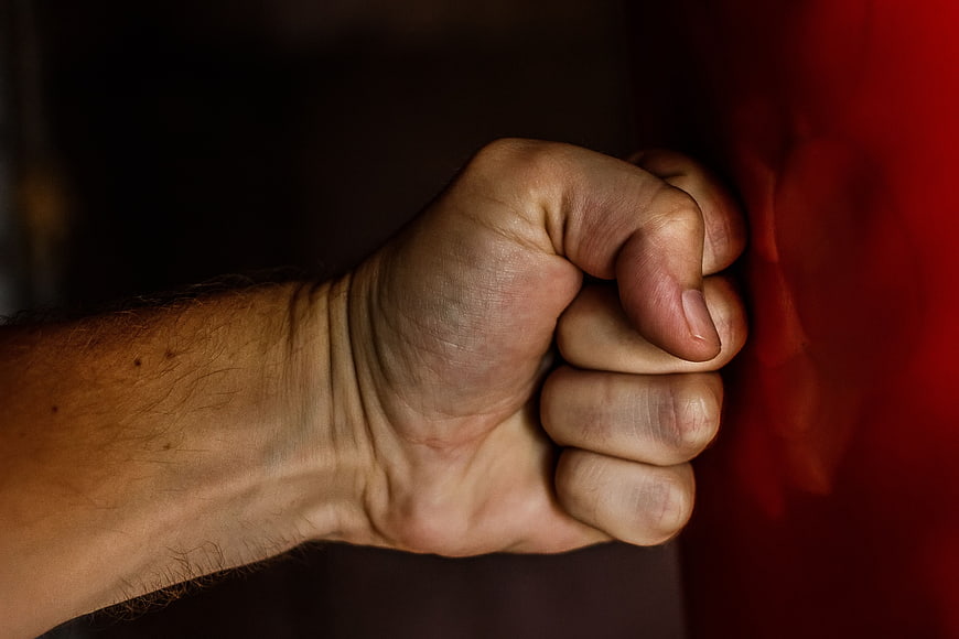 Close-up of clenched fist against red background