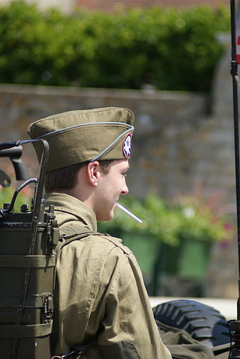 Young soldier in WWII uniform smoking cigarette in profile