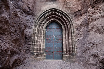 Ancient Gothic Stone Doorway Carved into Rock Face