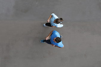 Aerial view of couple jogging on asphalt road