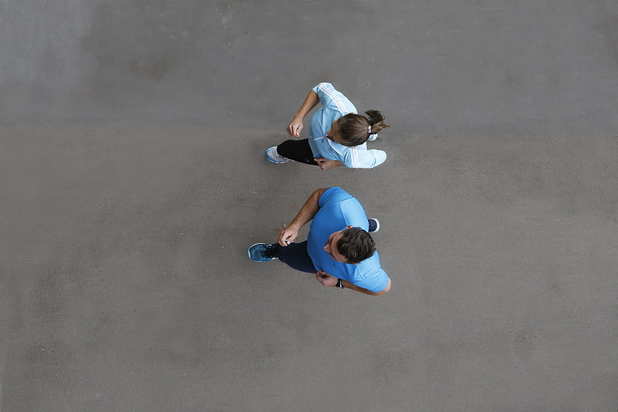 Aerial view of couple jogging on asphalt road
