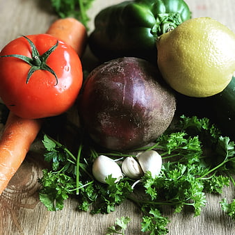 Fresh organic vegetables and herbs on rustic wooden table
