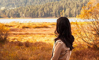 Woman in Beige Jacket Looking at Autumn Lake Landscape
