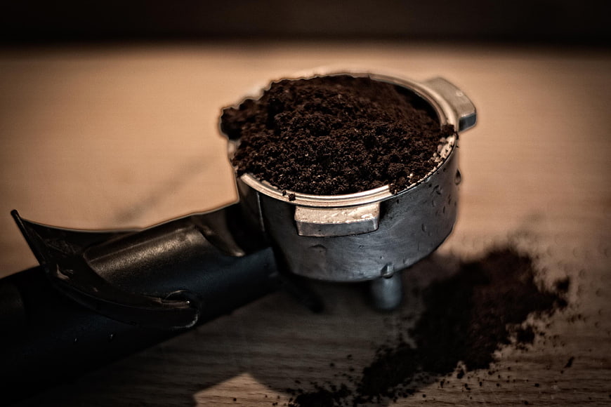 Close-up of espresso portafilter with ground coffee