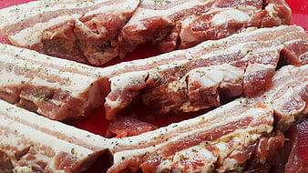 Raw Seasoned Pork Belly Ribs on Red Cutting Board