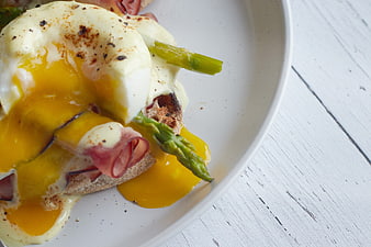 Close-up of Eggs Benedict with Runny Yolk and Asparagus