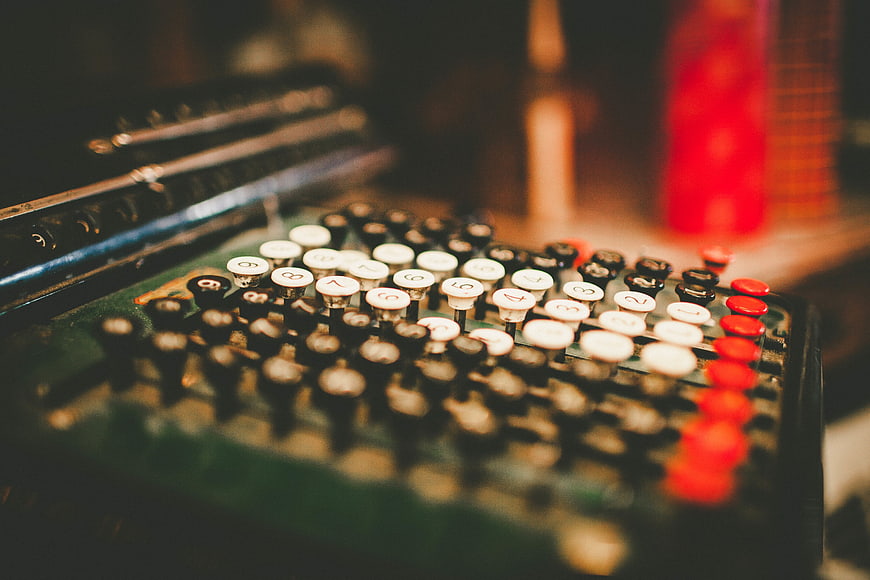 Close-up of vintage audio mixing console with colorful buttons