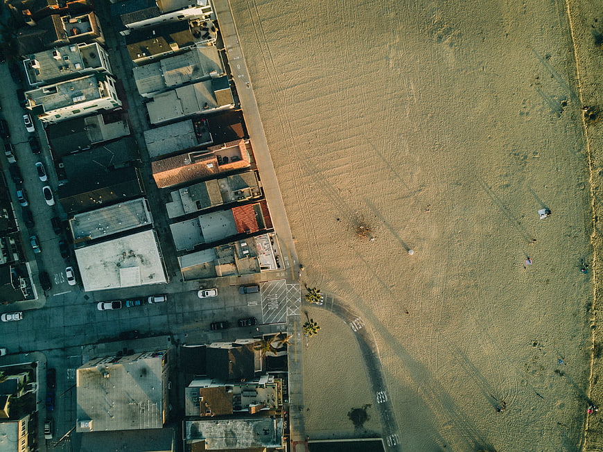 Aerial View of Coastal Neighborhood and Sandy Beach