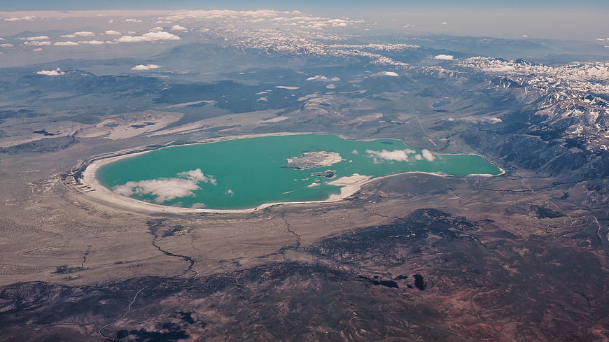 Aerial view of turquoise lake in arid mountain landscape