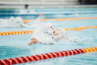 Swimmer performing butterfly stroke in pool