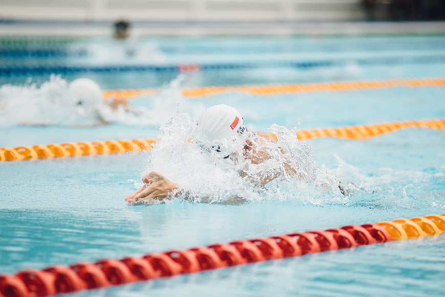 Swimmer performing butterfly stroke in pool