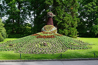 Flower Mound Sculpture In Lush Green Park Garden