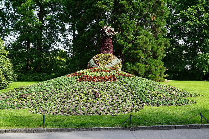 Flower Mound Sculpture In Lush Green Park Garden