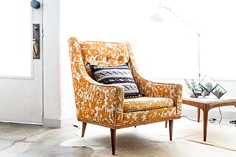 Orange patterned armchair in bright modern interior