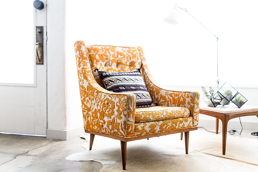 Orange patterned armchair in bright modern interior