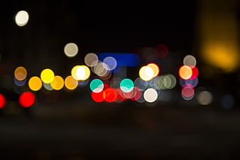 Colorful Bokeh Lights Against Dark Night Sky Background