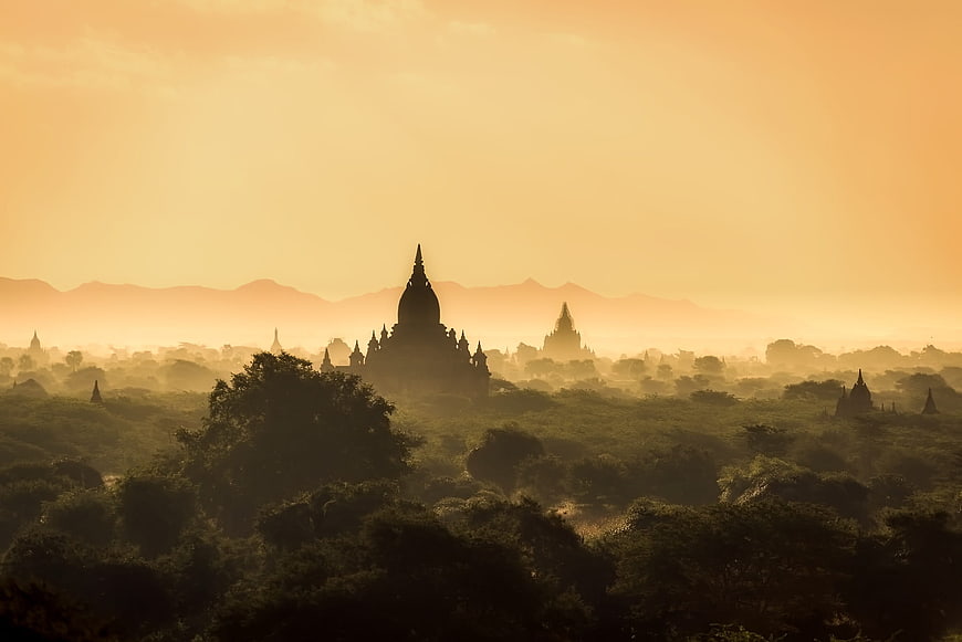 Silhouetted Pagodas in Misty Sunrise Landscape Myanmar