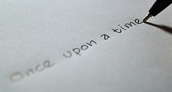 Pen writing once upon a time on white paper