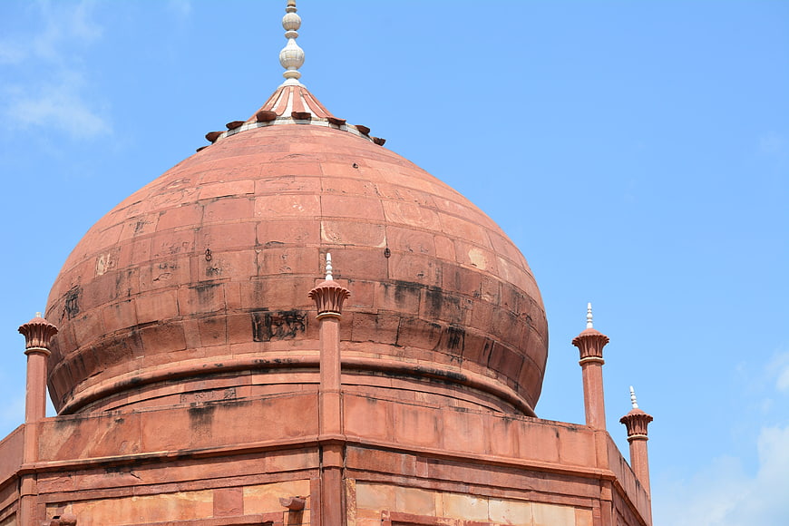 Red Sandstone Dome of Islamic Architecture Against Blue Sky