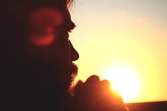 Silhouette of Man Looking at Sunset Horizon