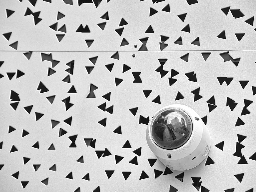 Security Camera on Perforated Metal Wall