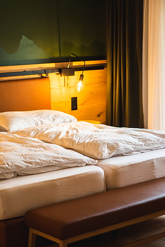Cozy Hotel Room with Unmade Beds and Warm Lighting