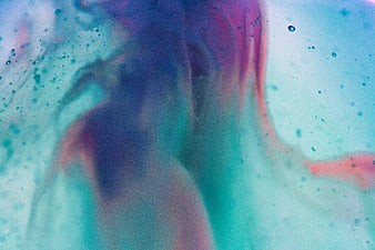 Abstract fluid art with blue, purple, and pink ink swirls