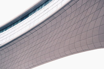 Modern curved building facade with geometric grid pattern