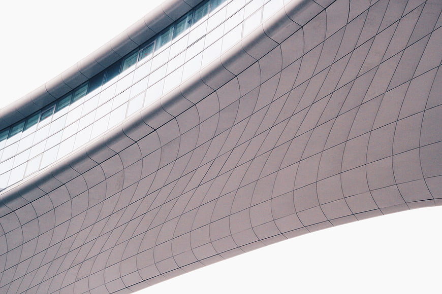 Modern curved building facade with geometric grid pattern