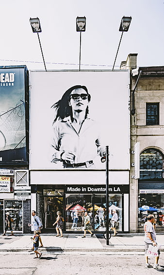 Urban street scene with large black and white billboard advertisement