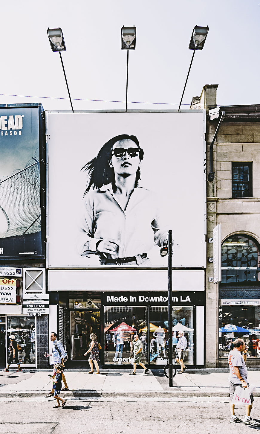 Urban street scene with large black and white billboard advertisement