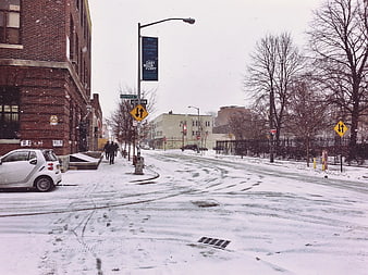 Snowy Brooklyn Street Scene with Brick Buildings and Parked Car