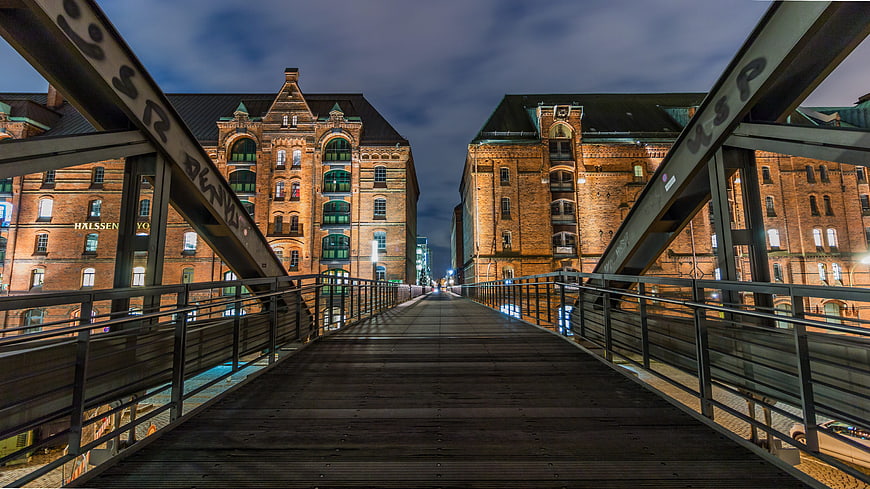 Night view of Speicherstadt Hamburg bridge and historic brick warehouses