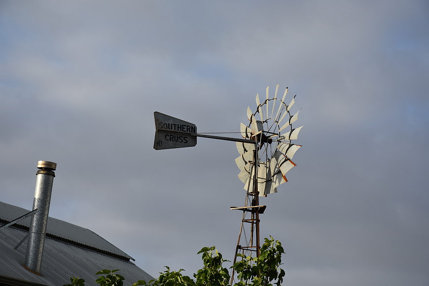 Vintage Southern Cross Windmill on Farm Roof