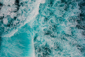 Aerial View of Turquoise Ocean Waves and White Sea Foam