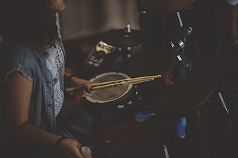 Musician Playing Electronic Drum Kit in Dimly Lit Studio