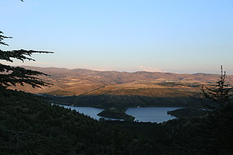 Scenic Lake View Surrounded by Forested Hills and Mountains