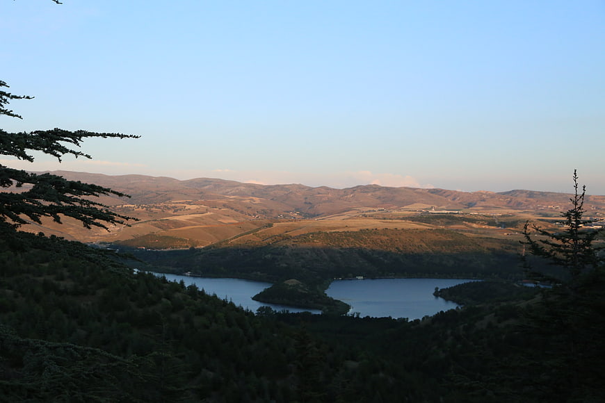Scenic Lake View Surrounded by Forested Hills and Mountains