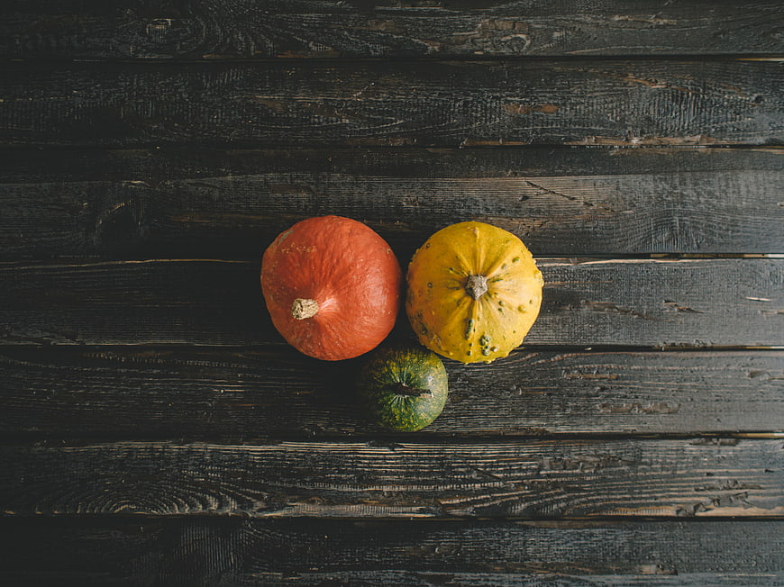 Top View of Colorful Pumpkins on Dark Wood