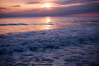 Serene Ocean Sunset with Golden Reflections and Gentle Waves