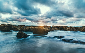 Dramatic Rocky Coastline with Long Exposure Water and Cloudy Sky