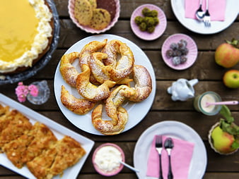 Overhead View of Traditional Polish Pączki and Desserts on Rustic Wooden Table